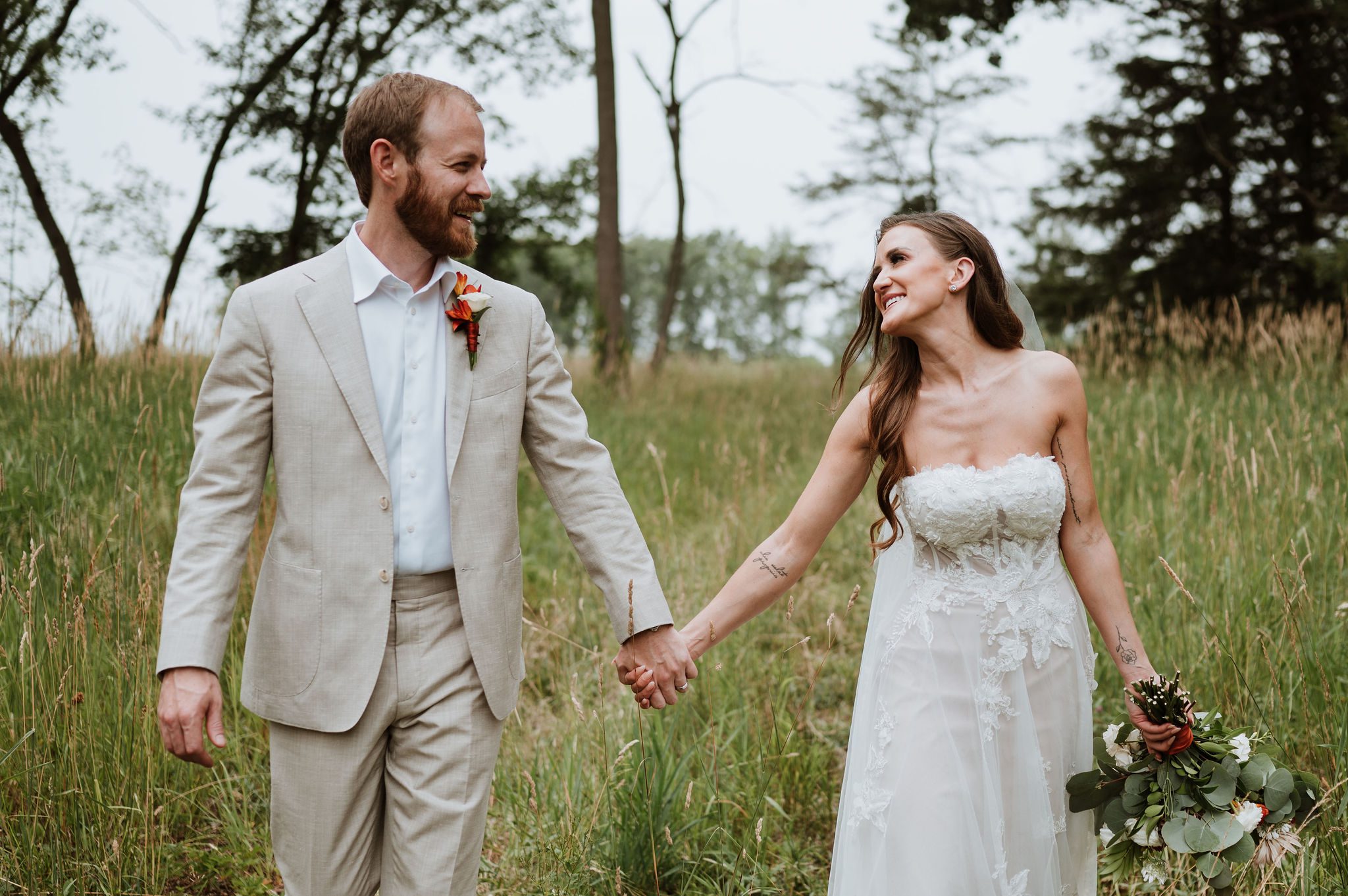 Couple portraits at Morton Arboretum surrounded by trees and open fields