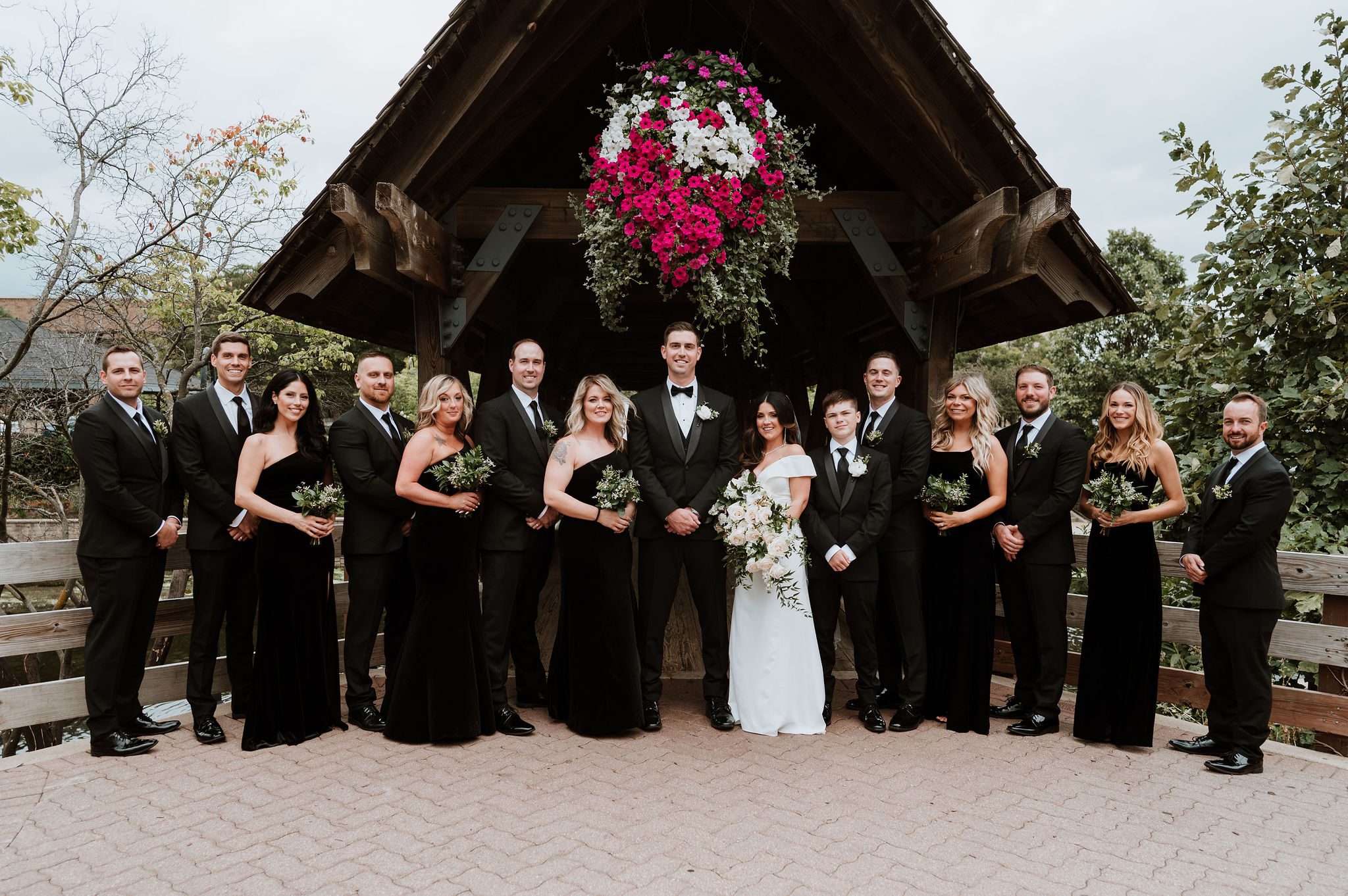 Wedding party at Naperville Riverwalk with bridges and paths